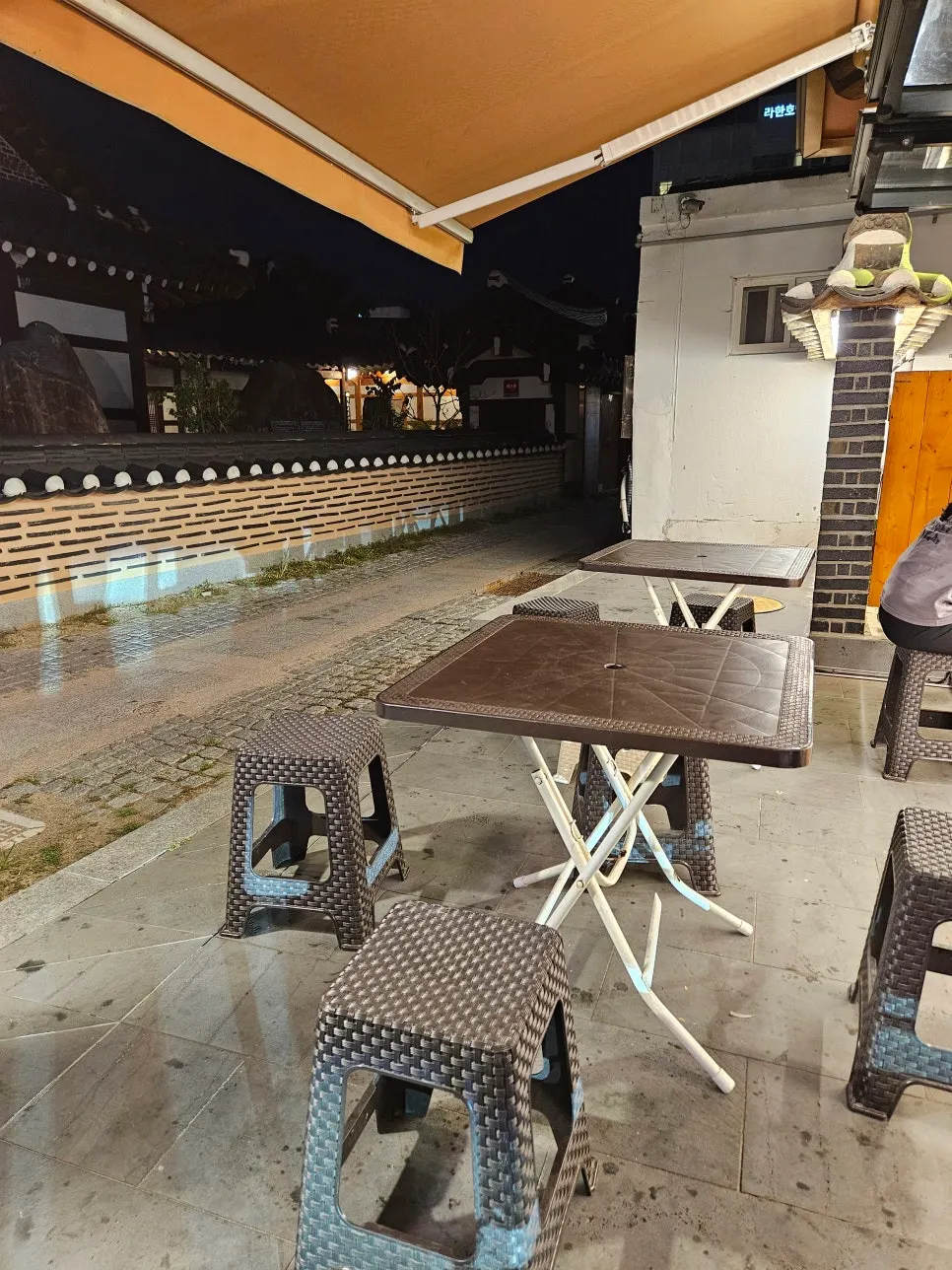 Outdoor tent-style tables beside the shop