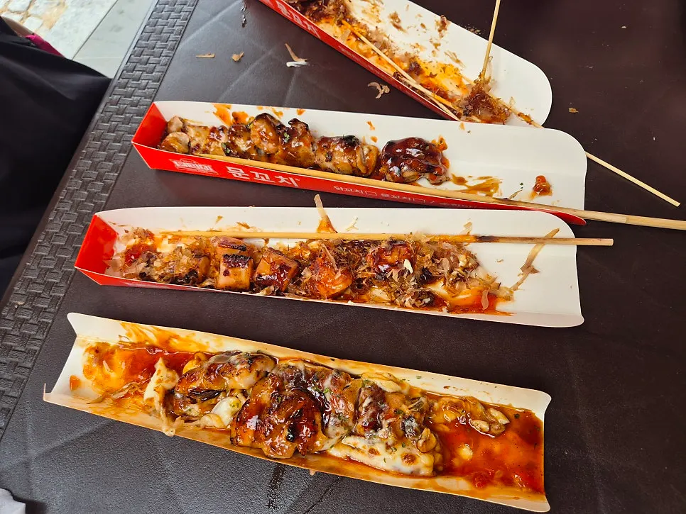 Skewers and slushy on the outdoor tables beside the shop