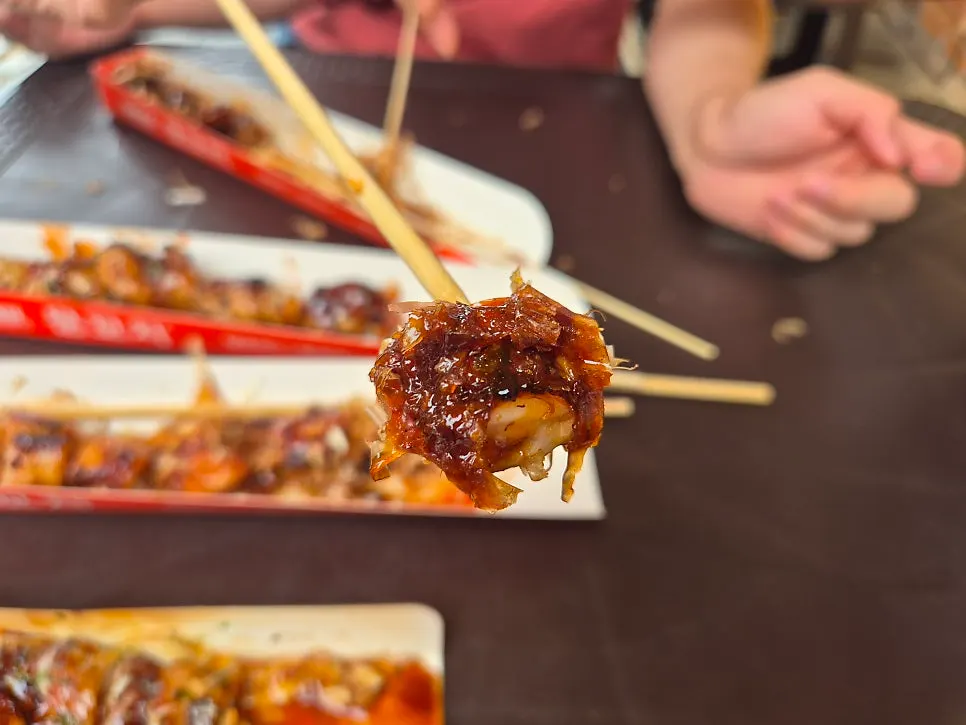 Cheese chicken skewer being eaten piece by piece off the skewer