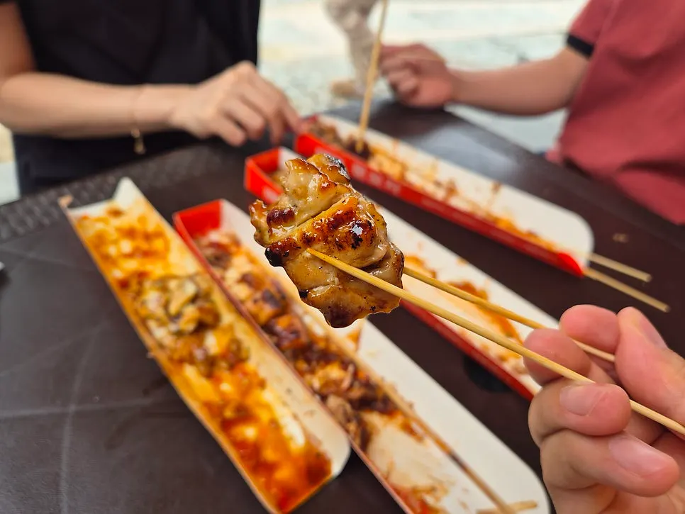 Octopus skewer topped with katsuobushi