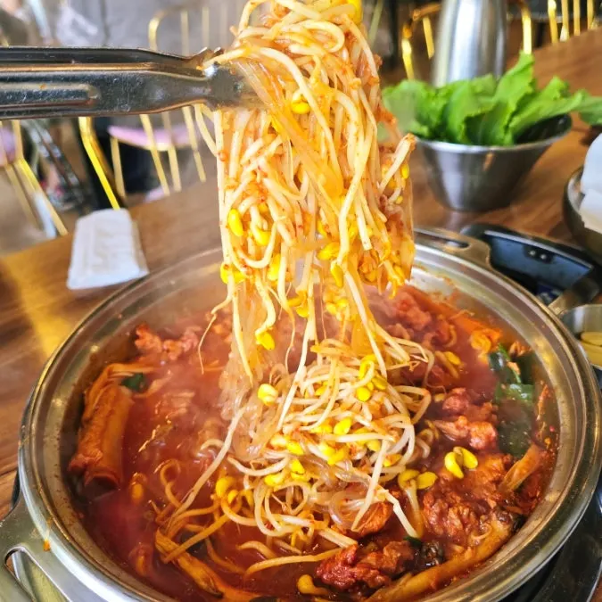 Soybean sprouts and glass noodles scooped from the galbi hot pot