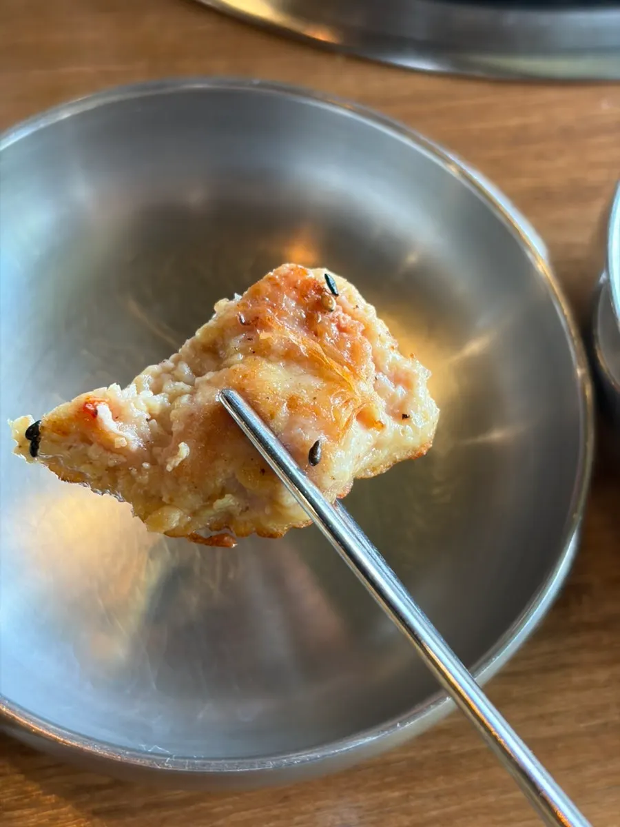 A piece of yukjeon picked up with chopsticks
