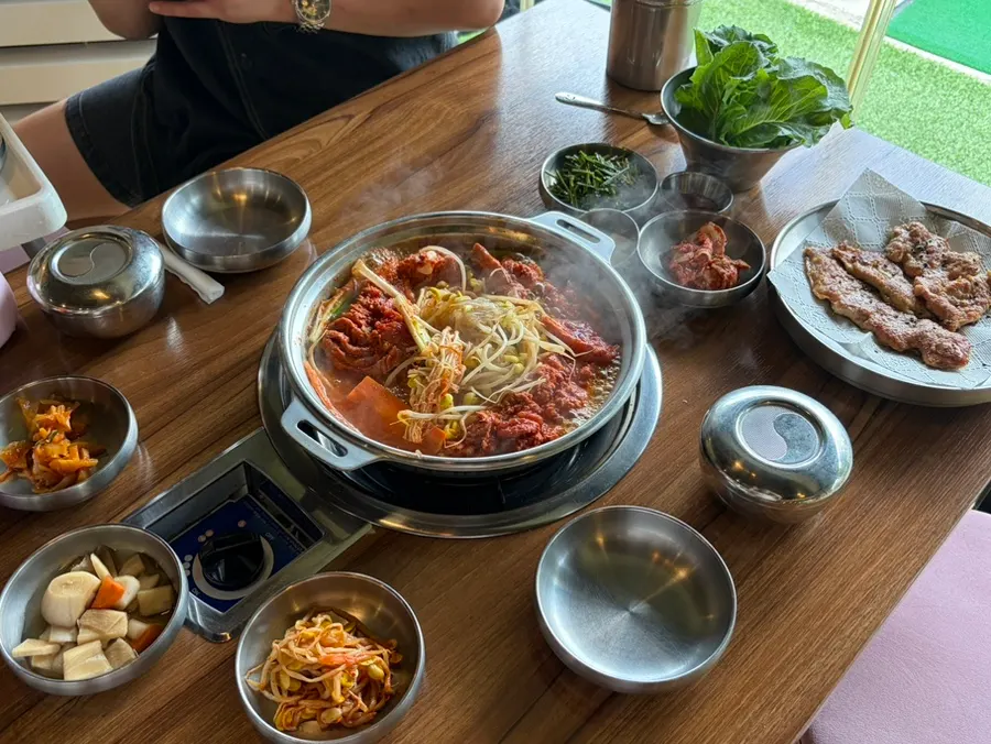 A table spread with galbi hot pot and yukjeon together
