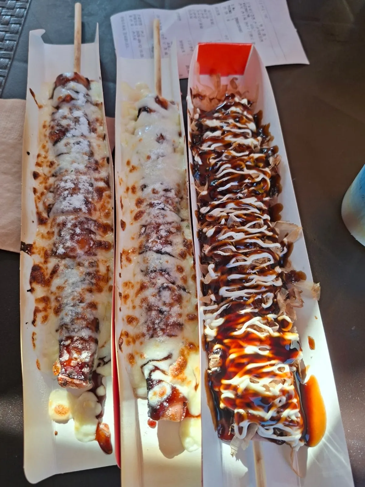 Close-up of an octopus skewer topped with katsuobushi