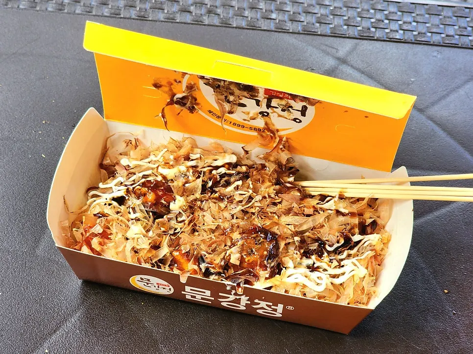 치즈닭꼬치를 들고 먹는 모습