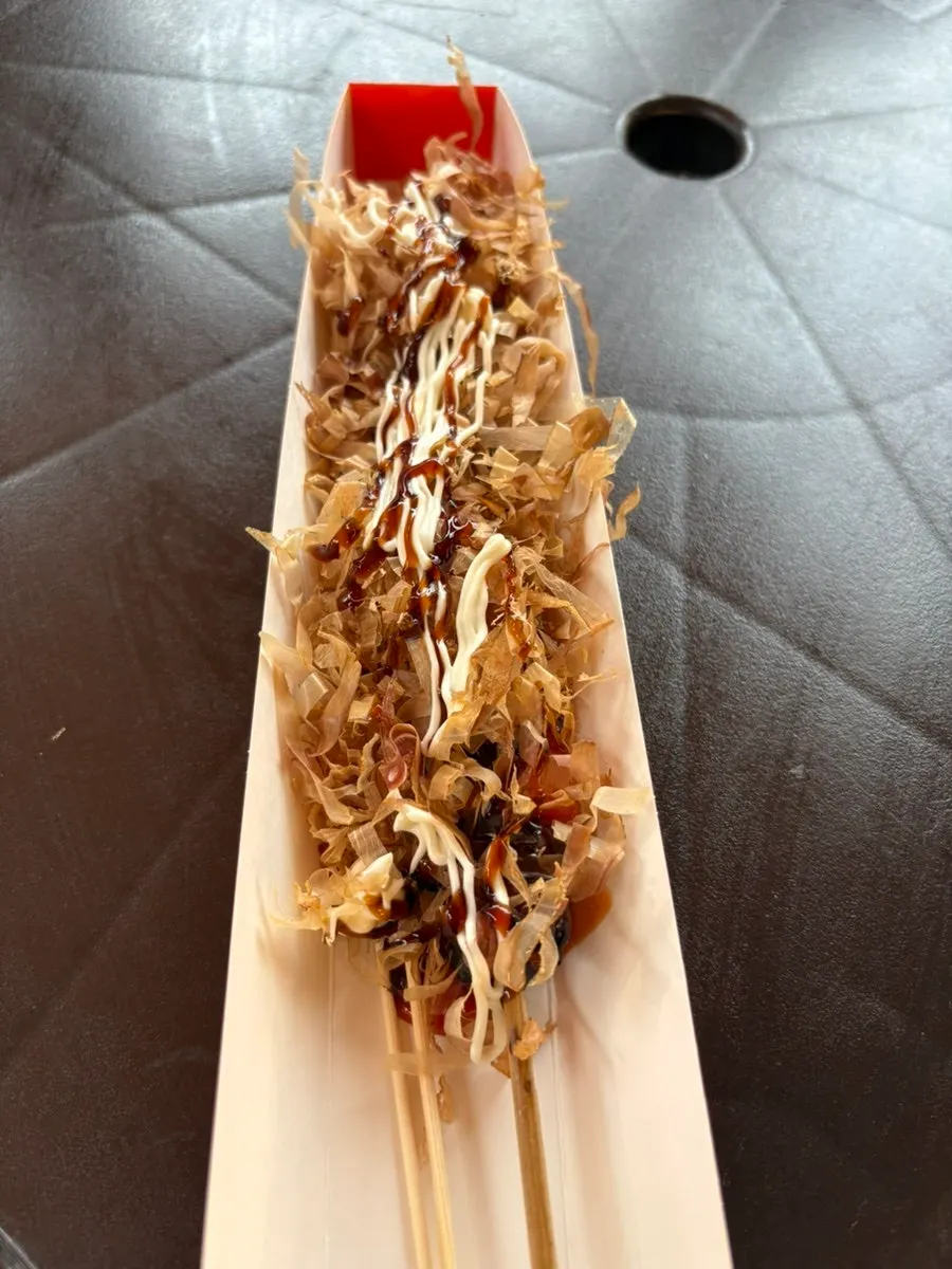 Octopus skewer served on a paper holder