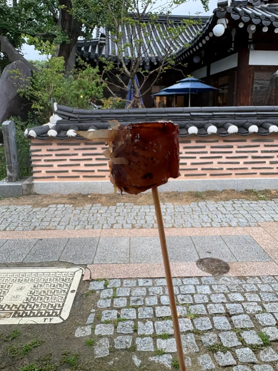Eating an octopus skewer by hand