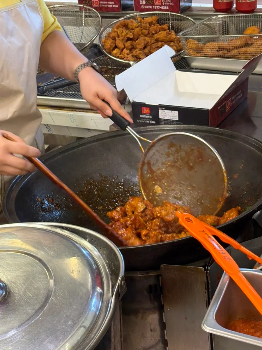 Shrimp and chicken being tossed in spicy sauce