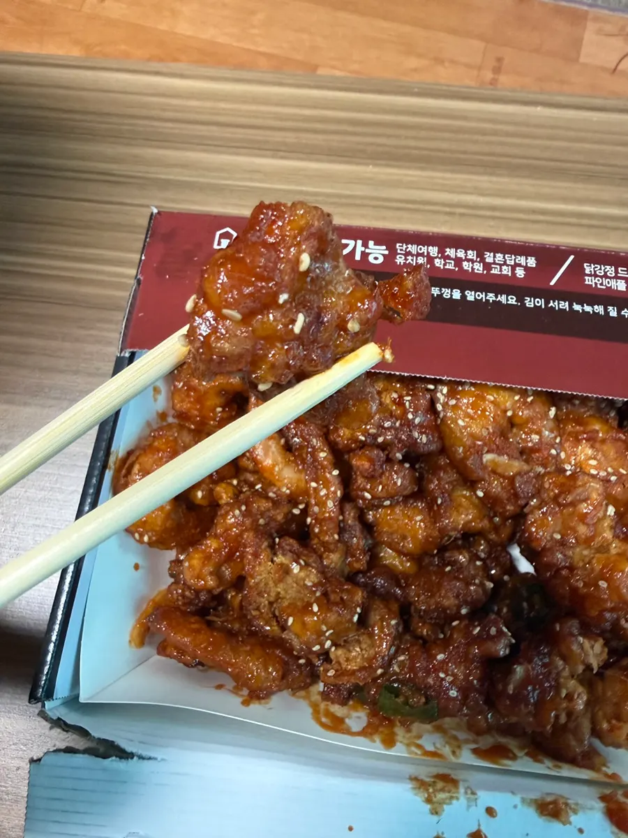 Spicy dakgangjeong mixed with sliced chili peppers