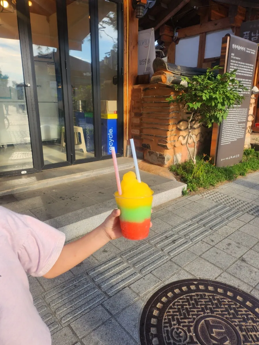 Self-serve slushy machine with mango, green apple, and strawberry flavors
