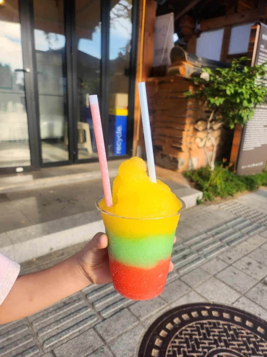 Cup filled with three slushy flavors