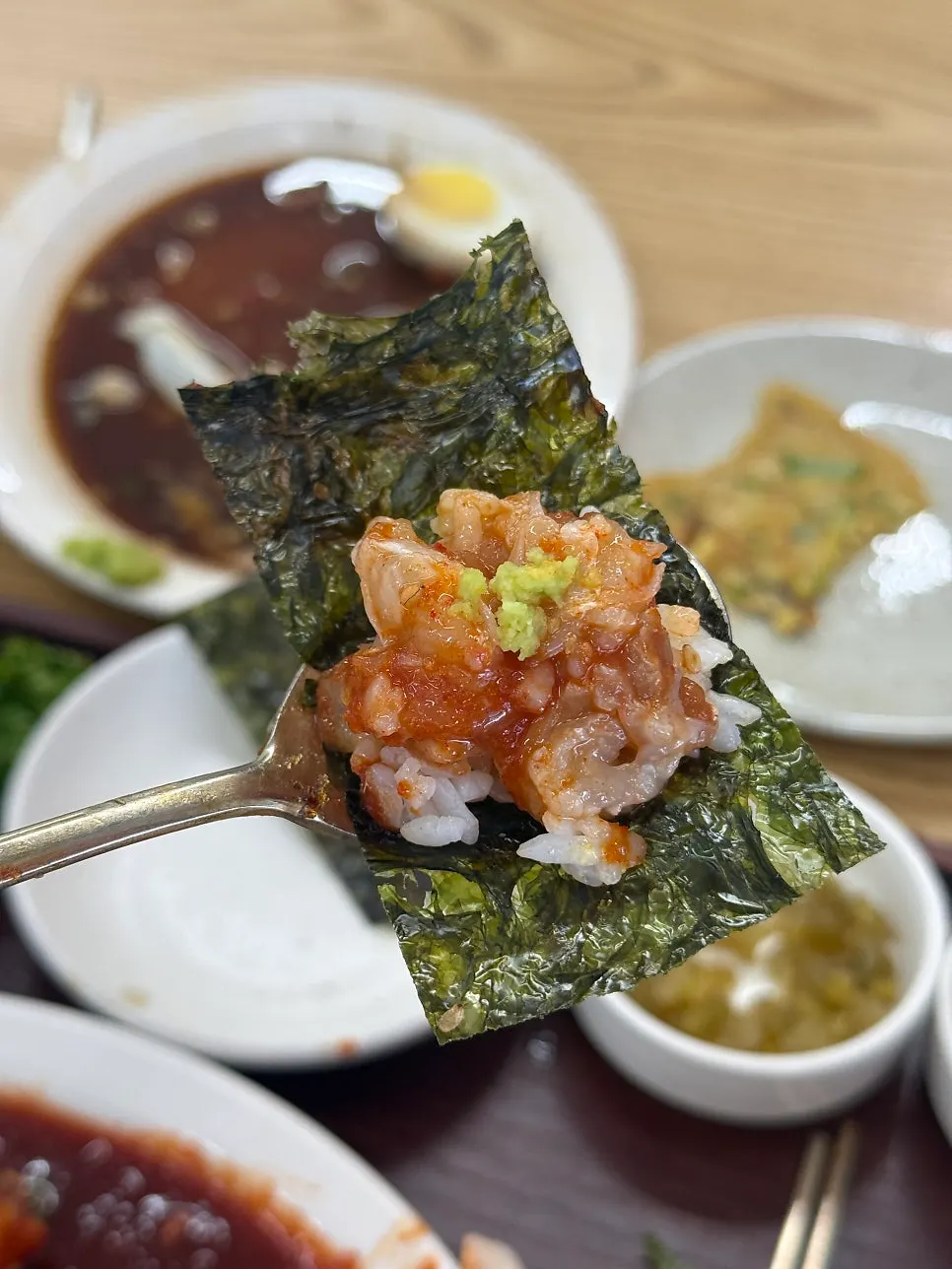 Spicy crab piled onto mini savory pancake side dish