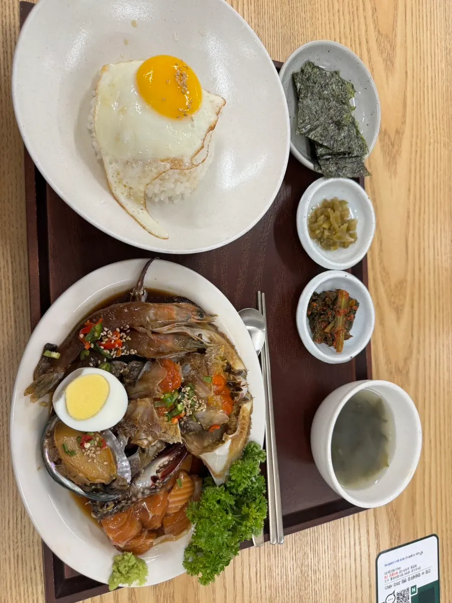 Neatly arranged soy-marinated seafood set meal