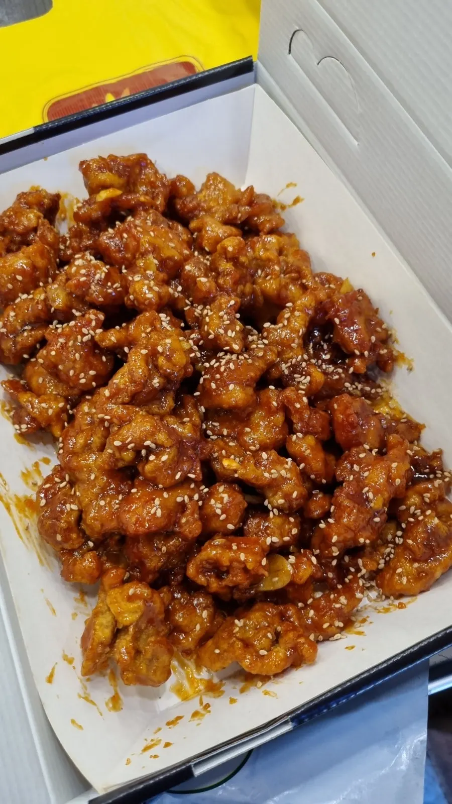 Hot dakgangjeong waiting to be packed for takeout