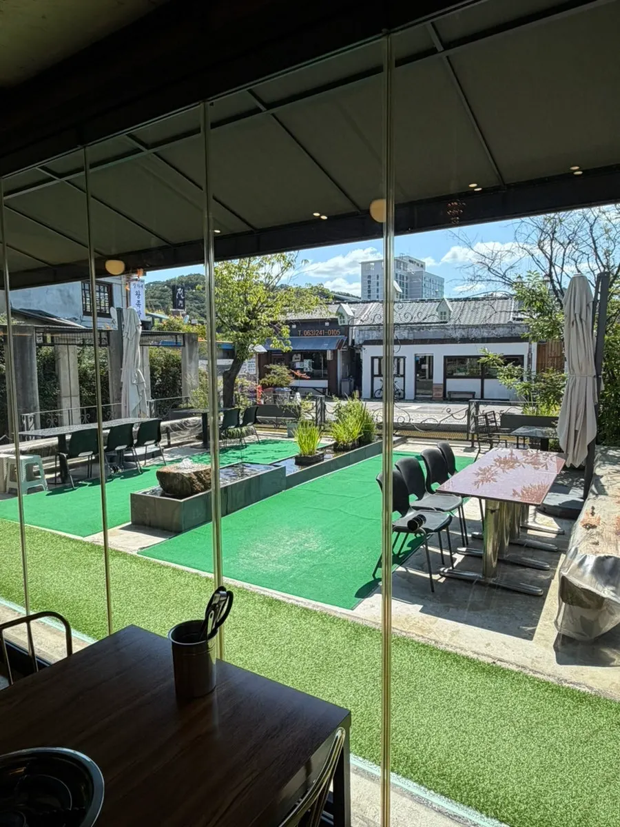 Interior with a pond visible through floor-to-ceiling windows