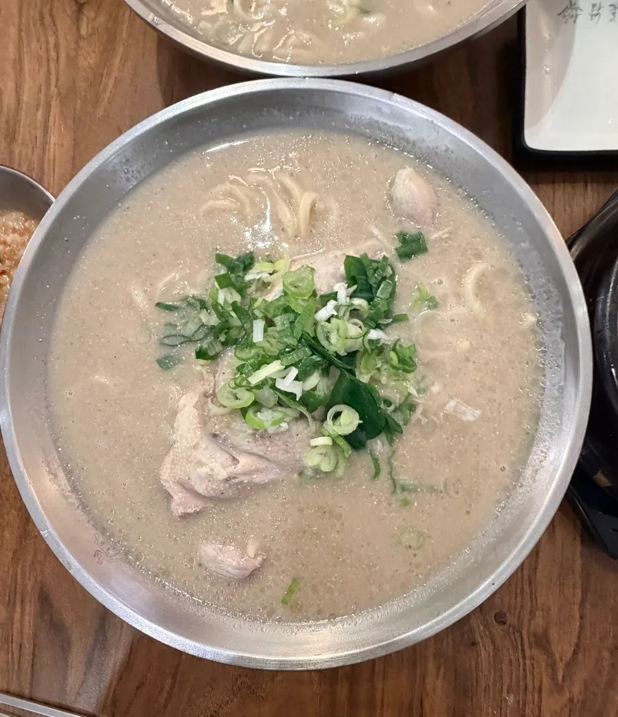 Chicken kalguksu broth with perilla powder mixed in