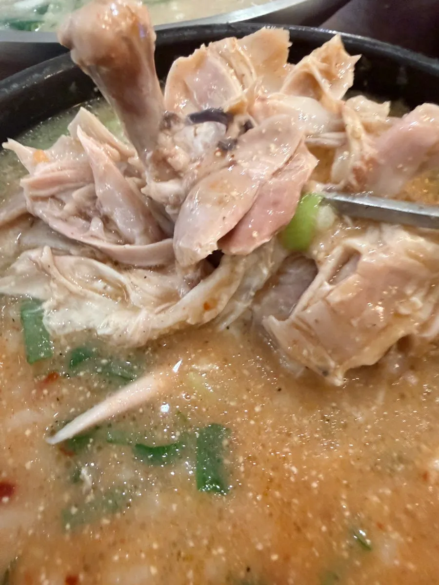 A spoonful of spicy chicken gomtang broth