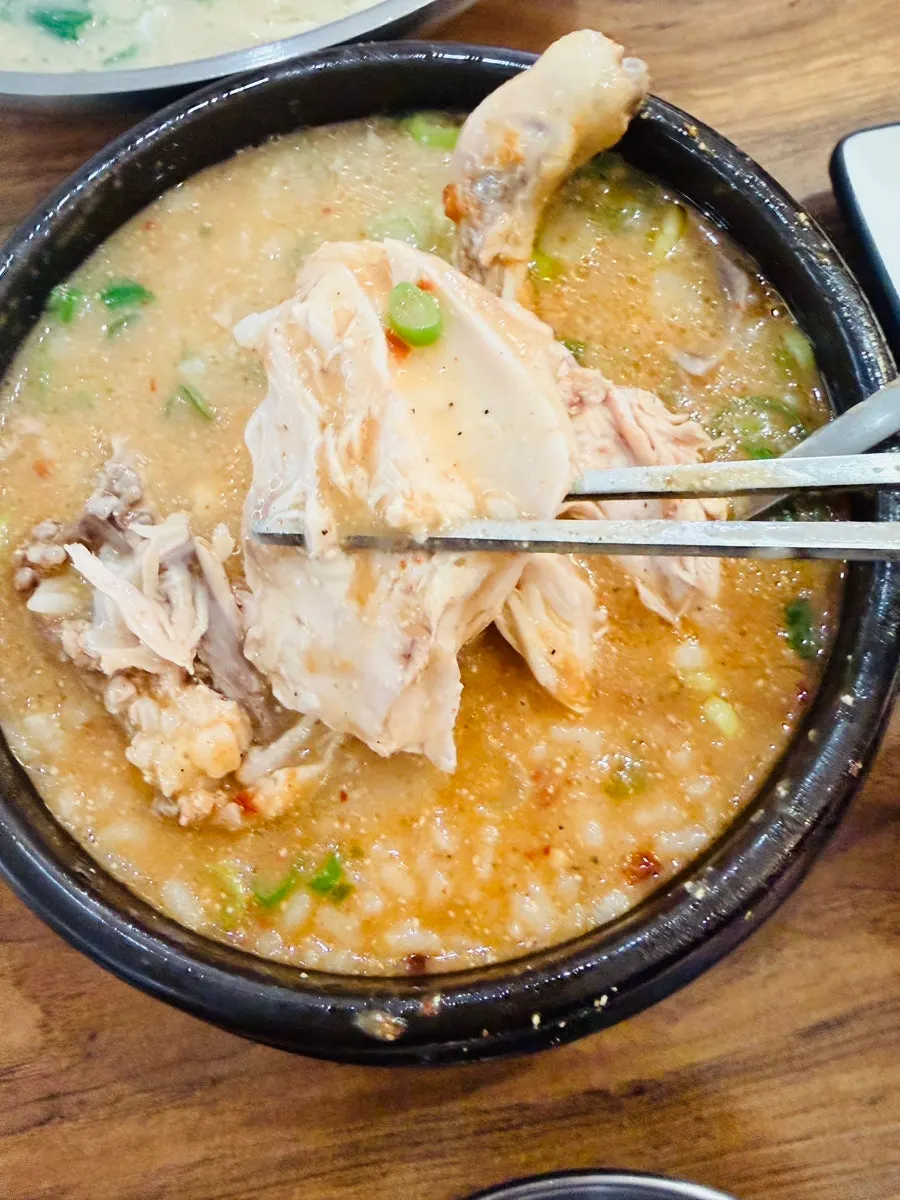 A full bowl of spicy chicken gomtang with rice mixed in