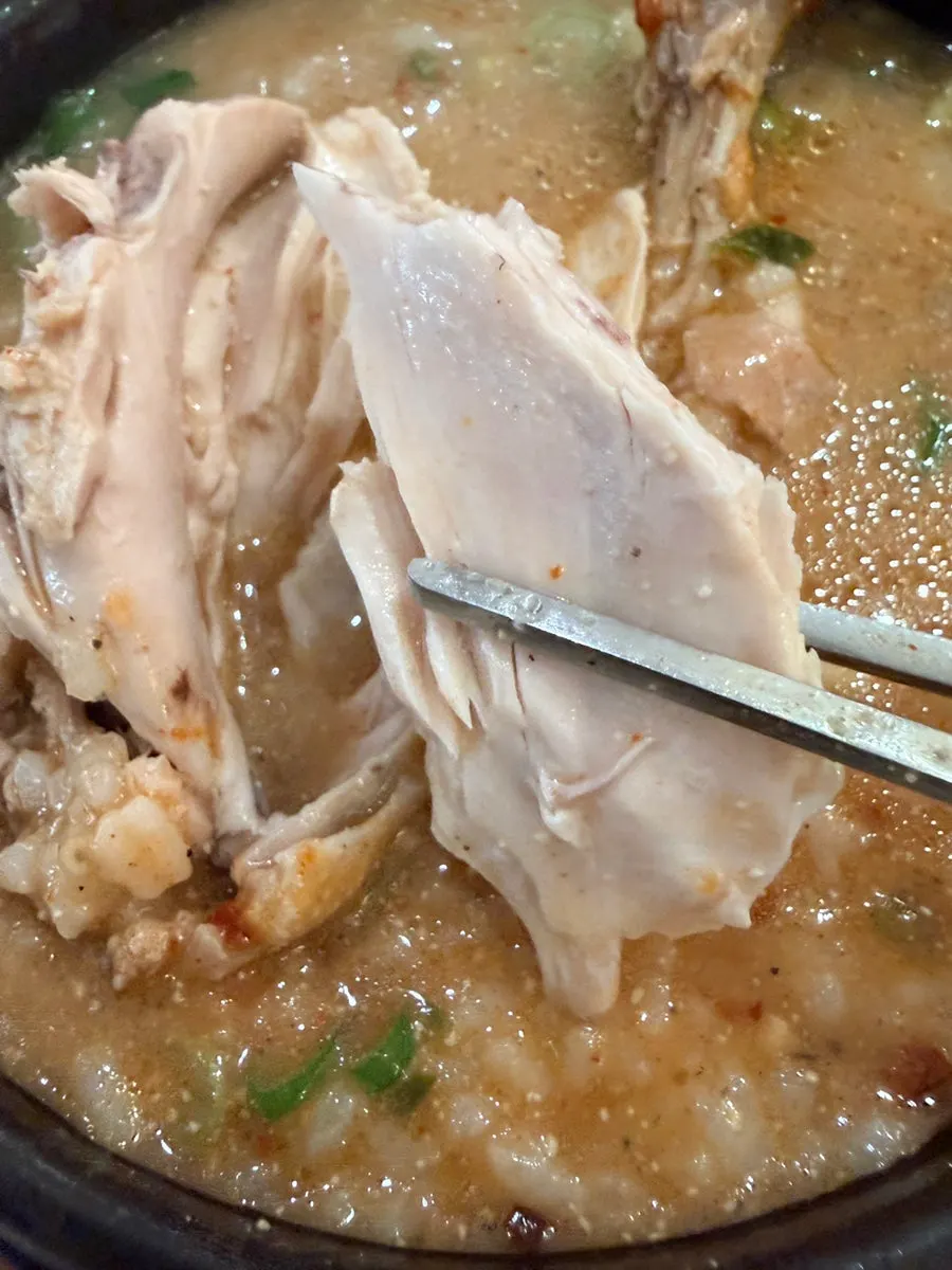 Chopsticks lifting chicken kalguksu noodles