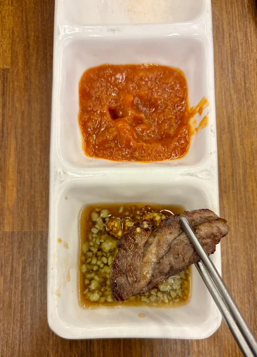 A piece of grilled hanwoo dipped in salt