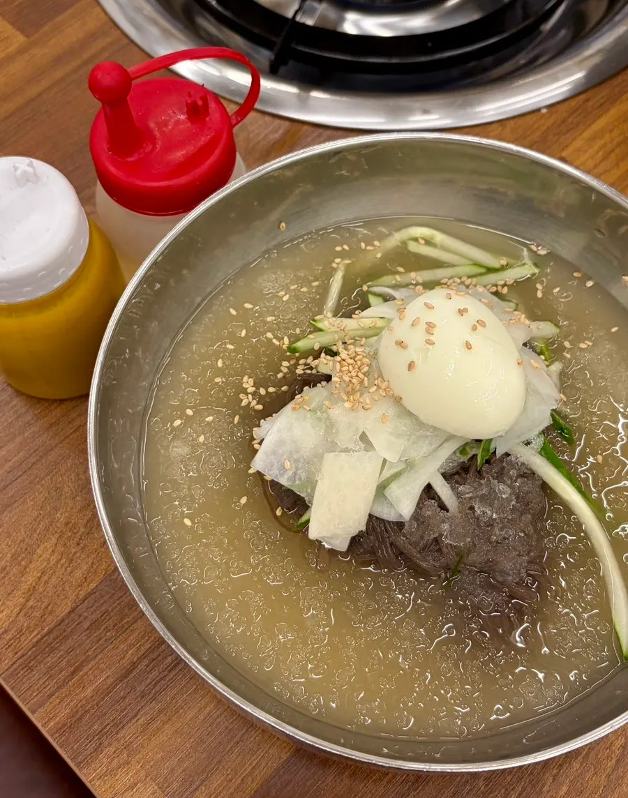 A bowl of mul naengmyeon ordered alongside the meat