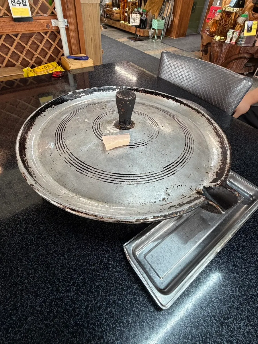 Thick-cut fresh pork belly on a cast-iron lid grill