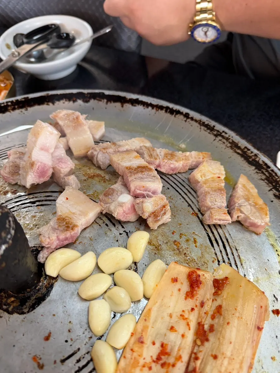 Grilled pork belly served with side dishes