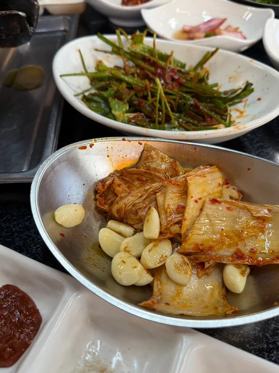 Aged kimchi and garlic grilled on the cast-iron lid