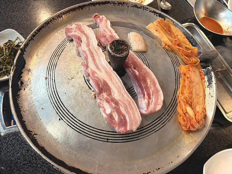 Aged kimchi grilling together in the pork belly fat