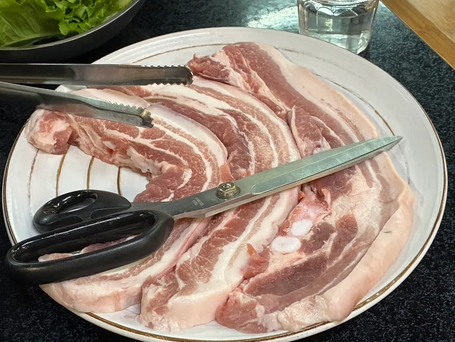 Three thick chunks of raw pork belly