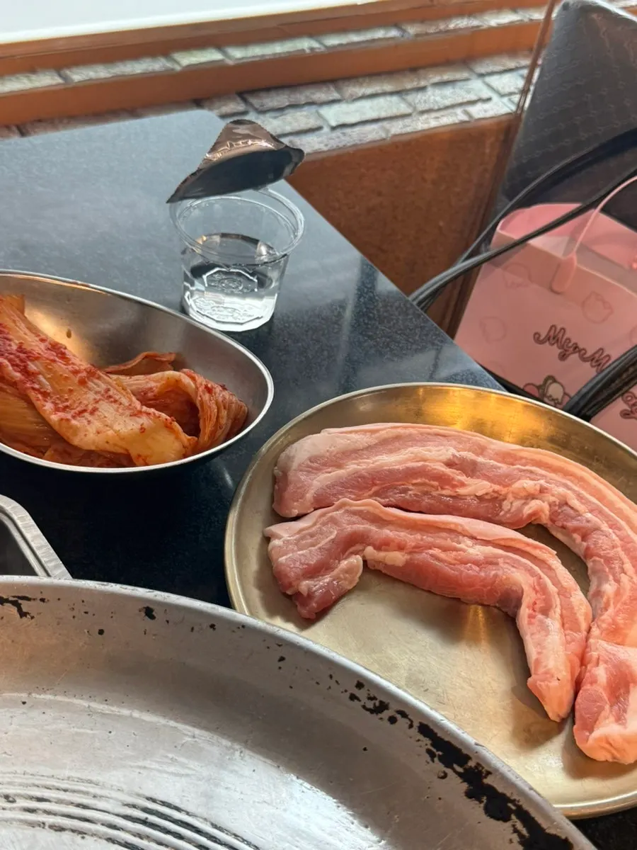 Fresh pork belly on the cast-iron lid