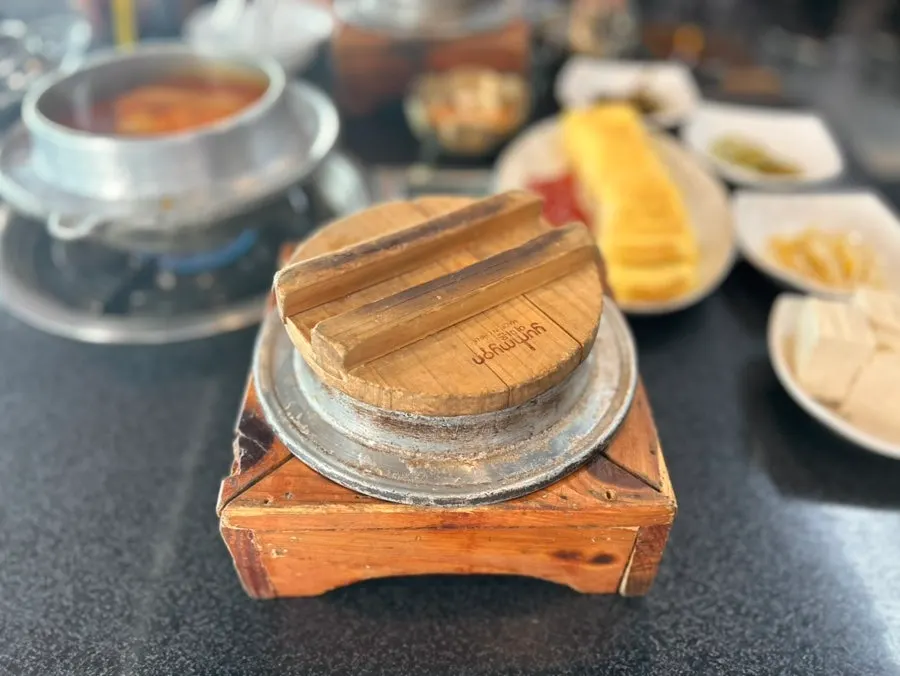 Open pot rice and kimchi stew with lids removed