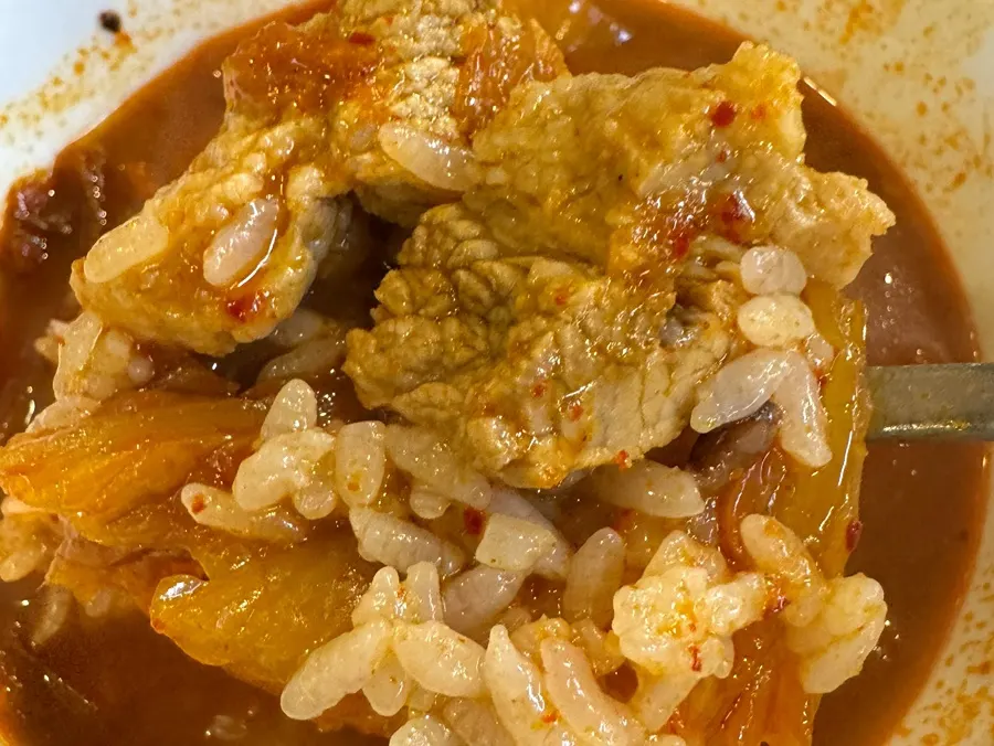 Galbi kimchi stew mixed into a bowl of rice
