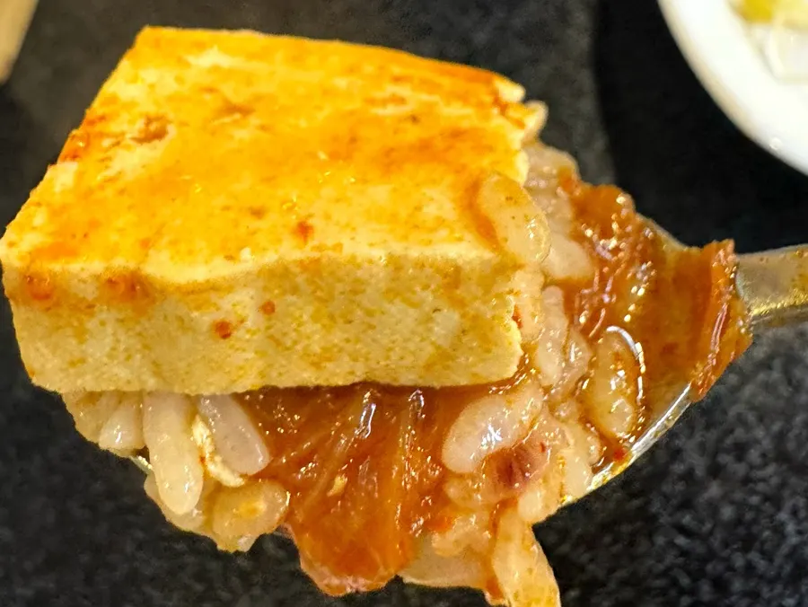 A big chunk of tofu added to the stew