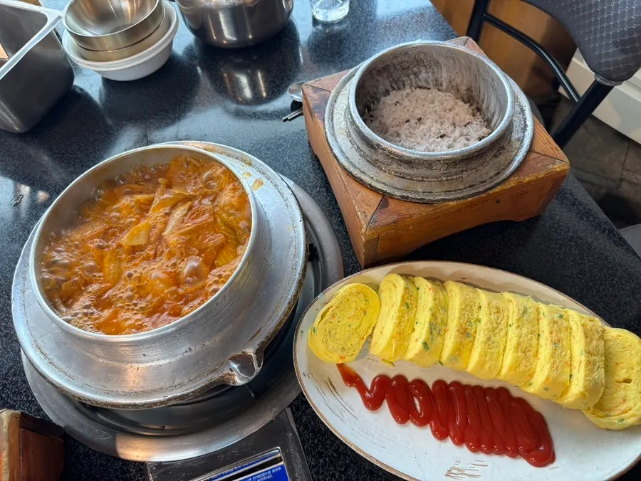 Cast-iron galbi kimchi stew with a whole half-head of aged kimchi
