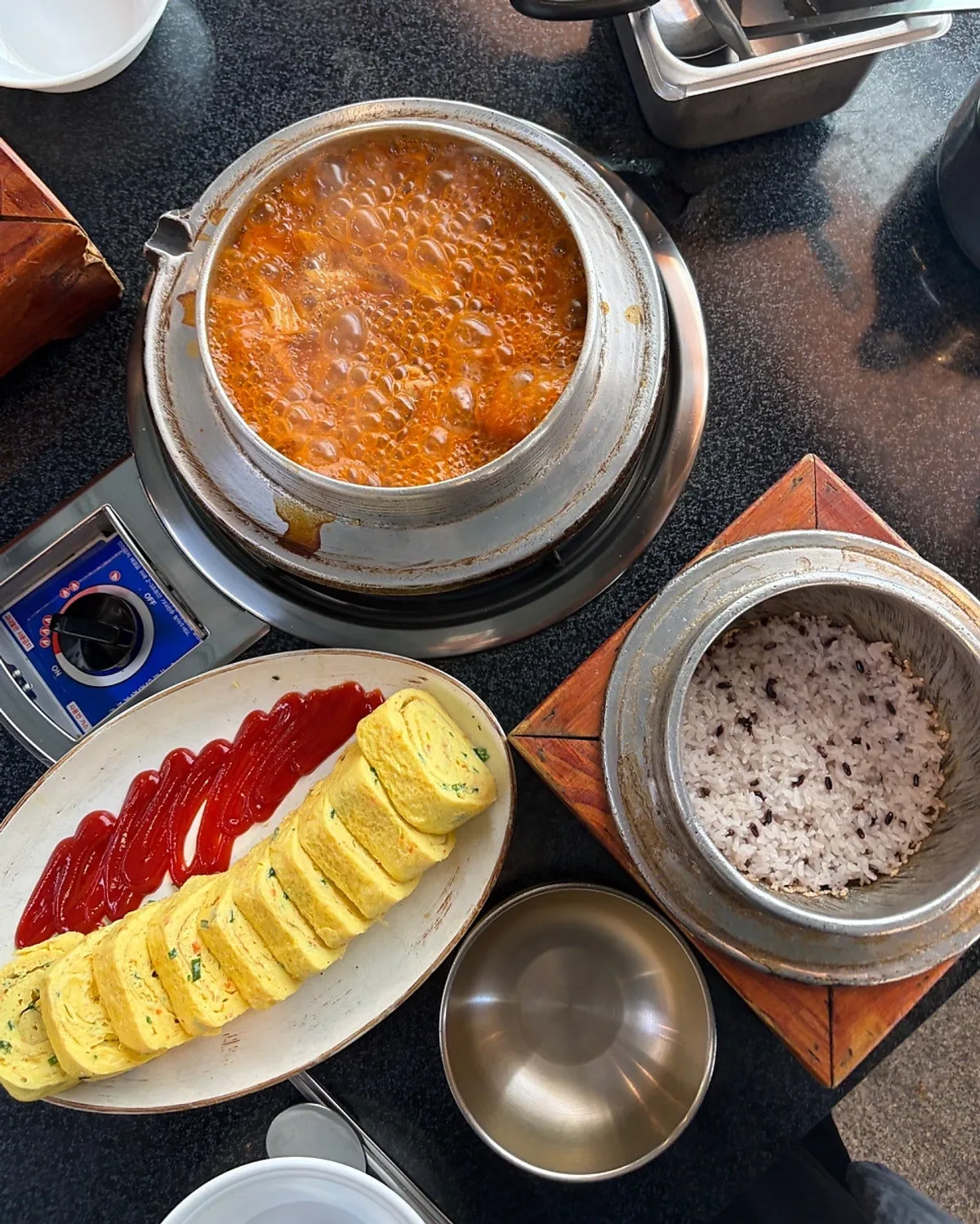 A full table setting of Jeonju House's aged kimchi galbi kimchi stew