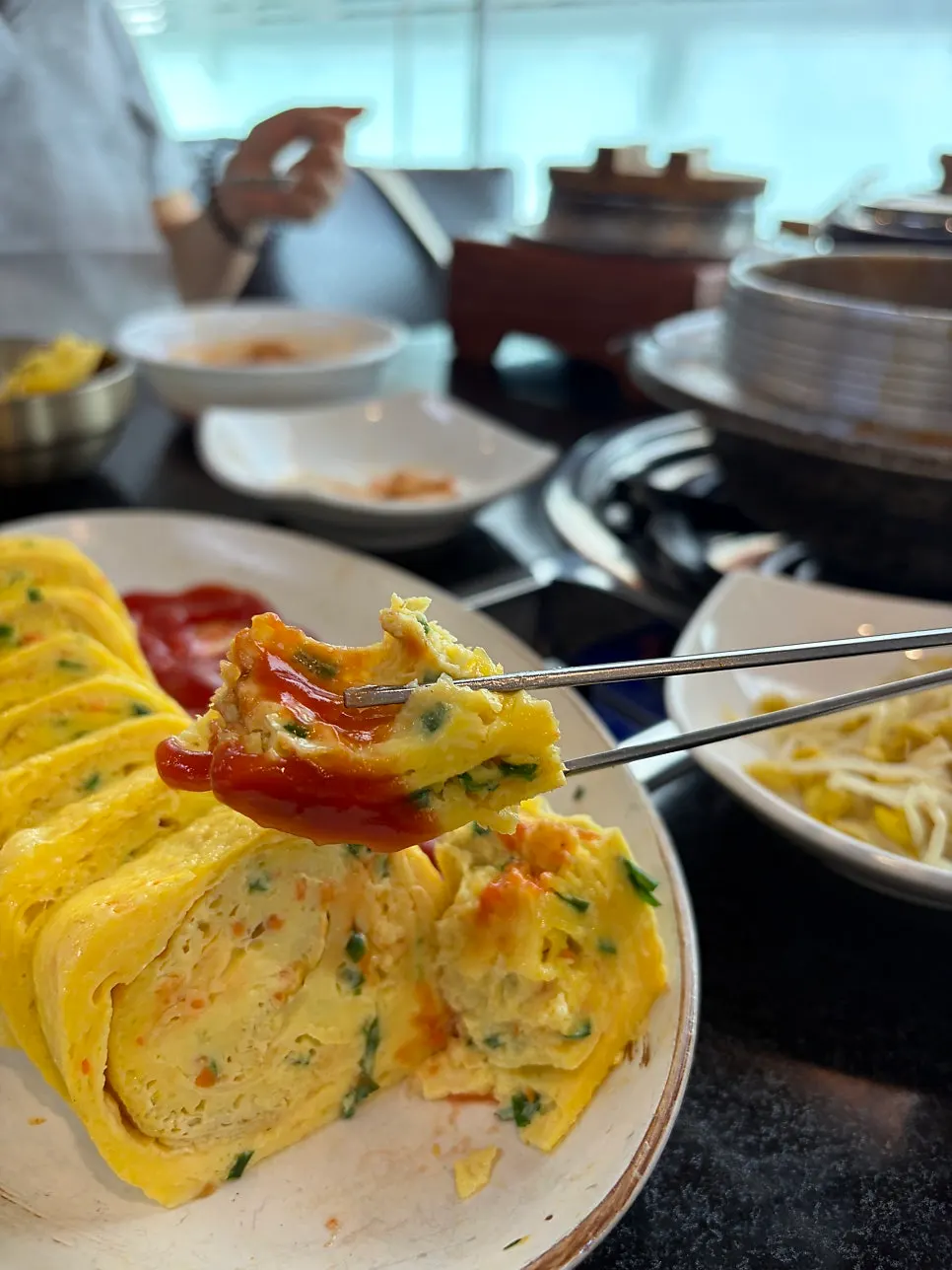King rolled omelet drizzled with ketchup