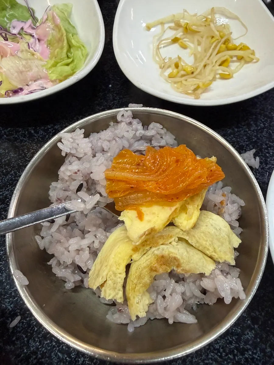 A bowl packed with kimchi and meat