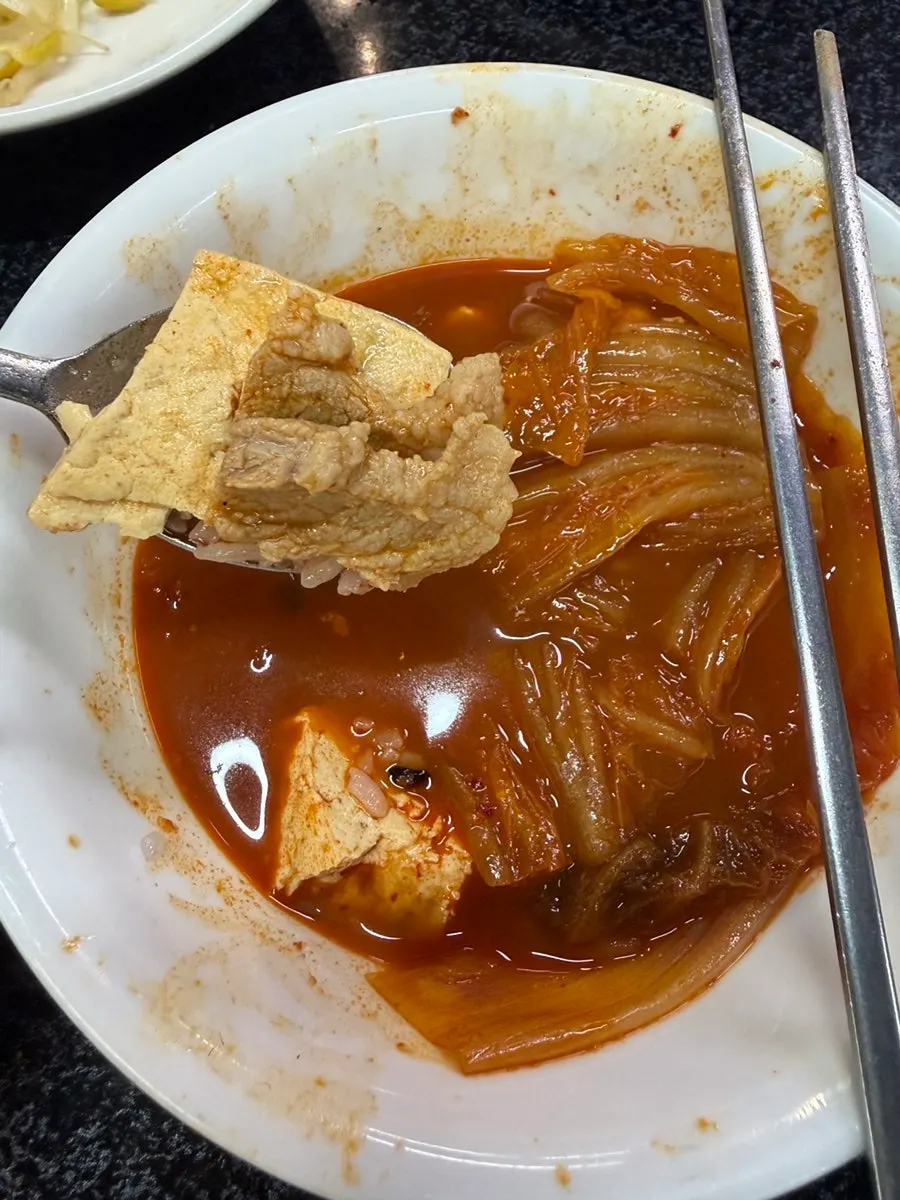 Soft tofu lifted out of the stew