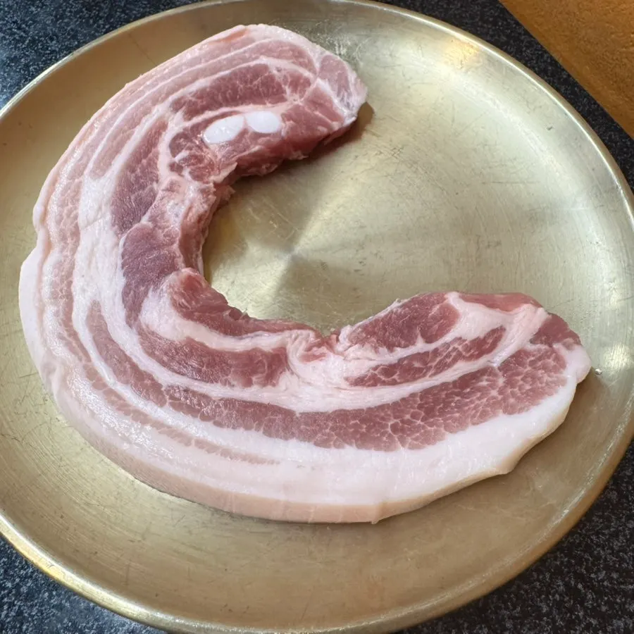 Two thick servings of cast-iron-lid pork belly