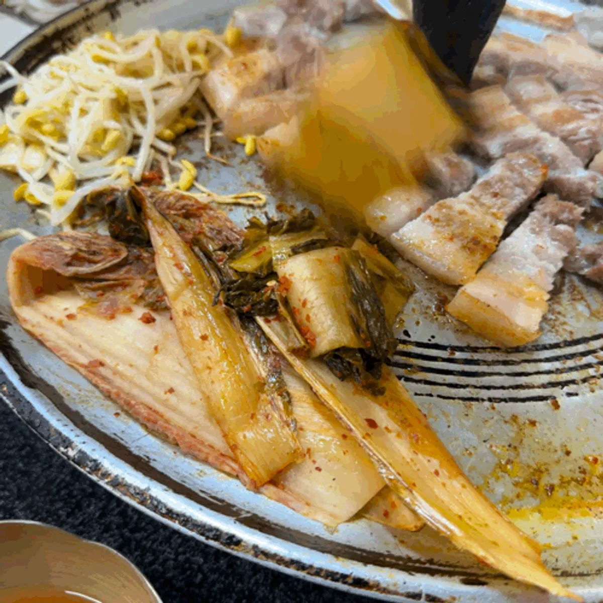 Aged kimchi and pork belly grilled together in the fat
