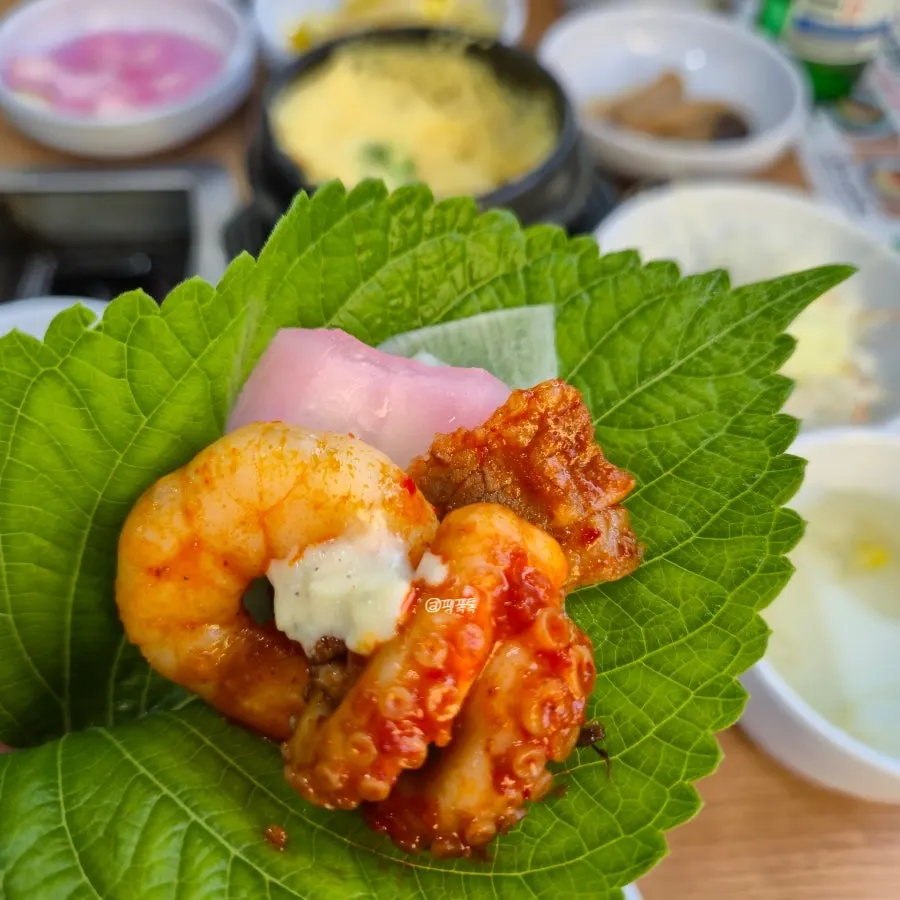 Jjukkumi wrapped in a lettuce leaf