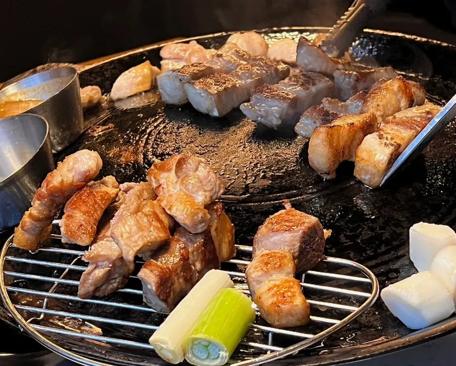 Aged meat cooking on the grill