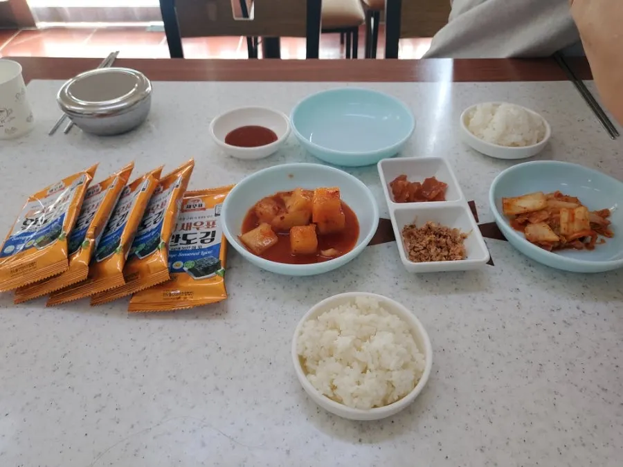 Kimchi, seaweed, salted shrimp relish side dishes and a soft-boiled egg