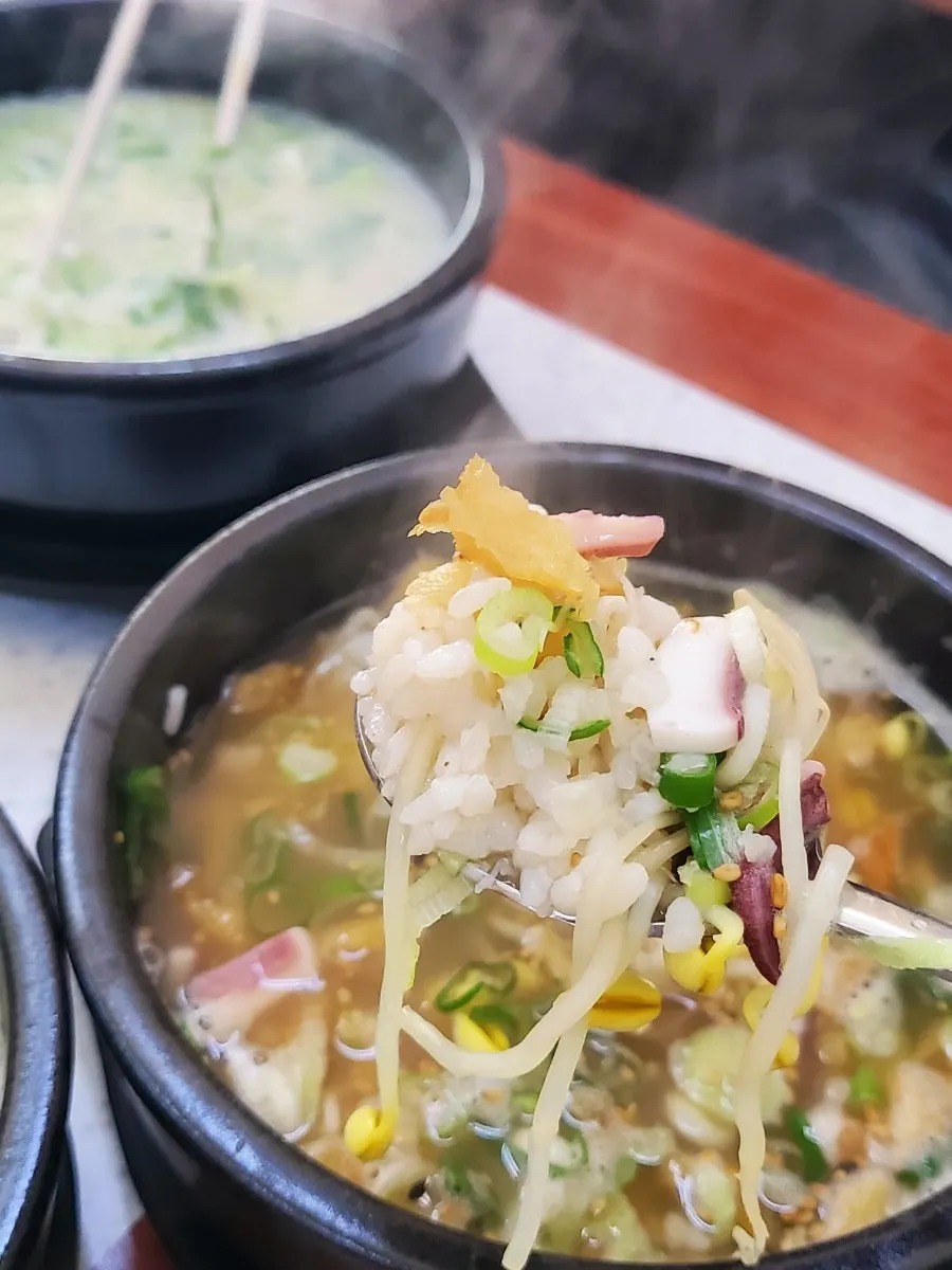 Squid pieces inside the hwangje bean sprout soup