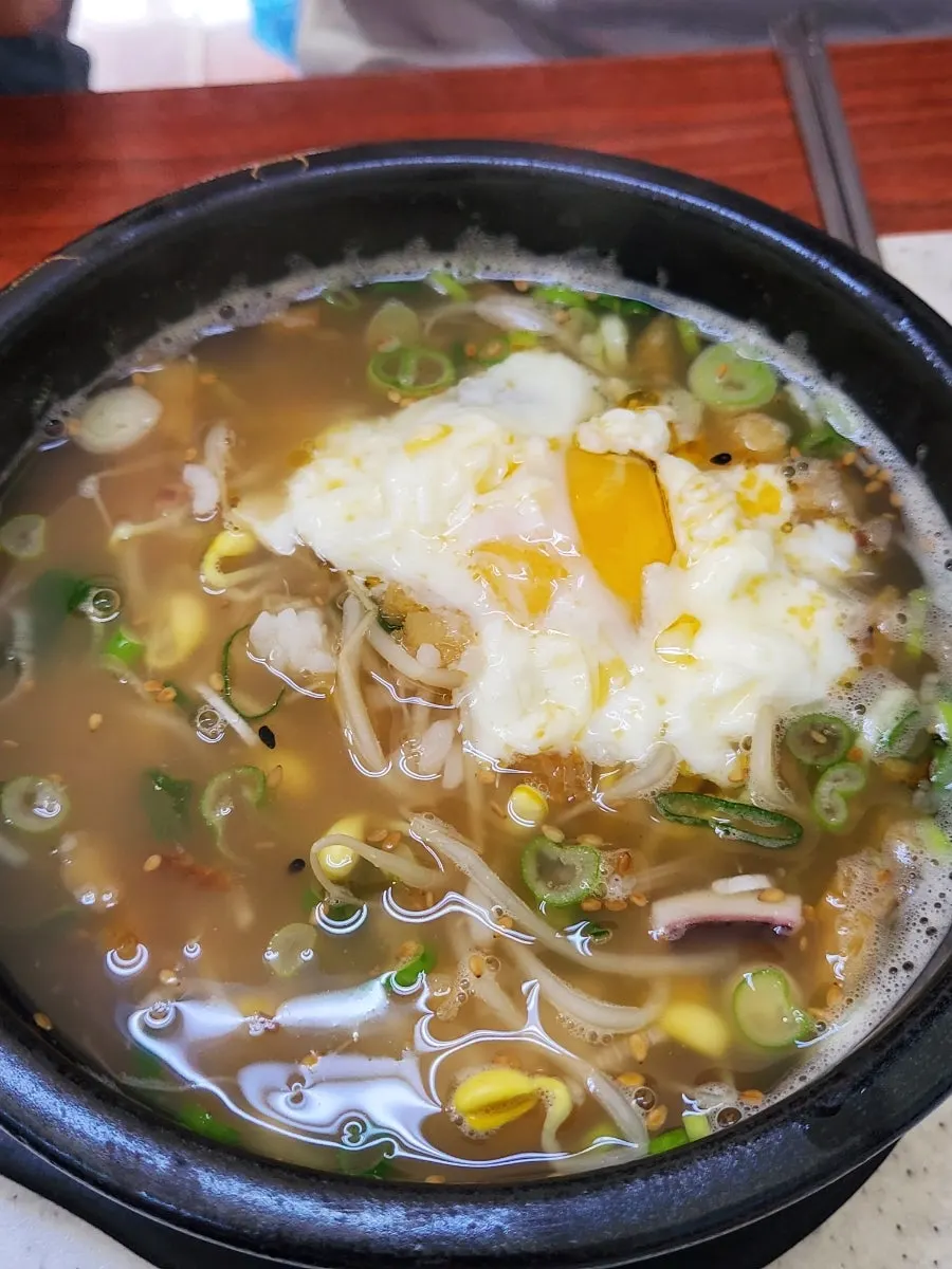 Two bowls of Ogeorijip's bean sprout soup set out on the table