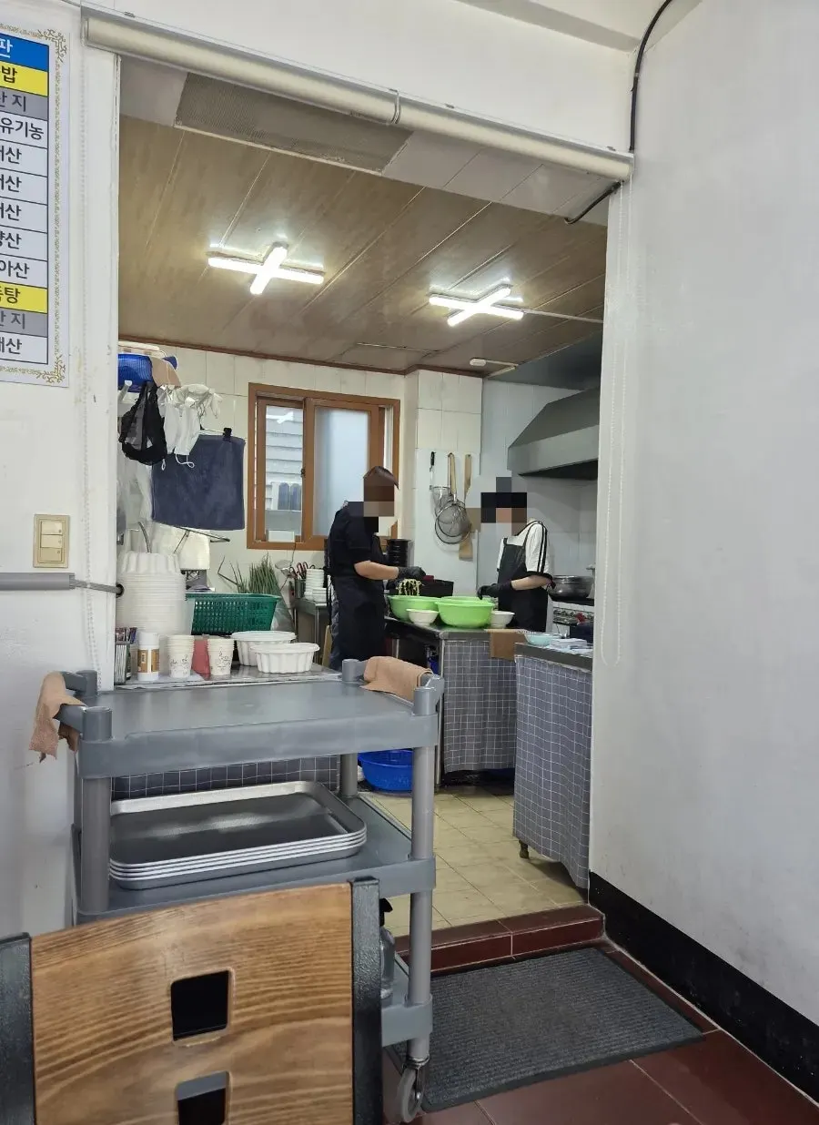 TV appearance photos on the wall and the open kitchen