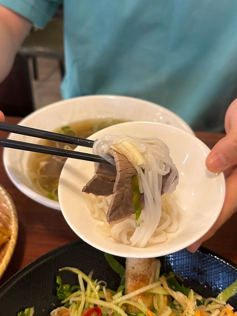 Noodles and toppings in the light broth of the brisket pho