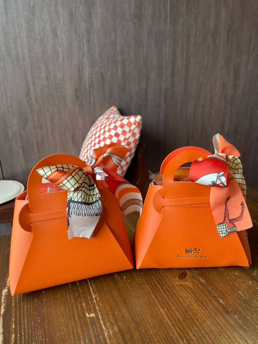 Orange mini bag wrapped with a scarf tied like a ribbon