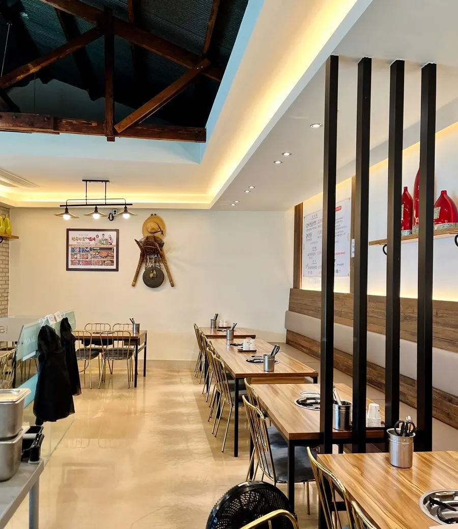 Restaurant interior with a visible hanok ceiling